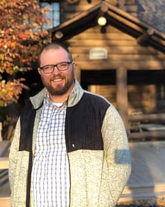 Scott Baietti in front of the lodge in the fall